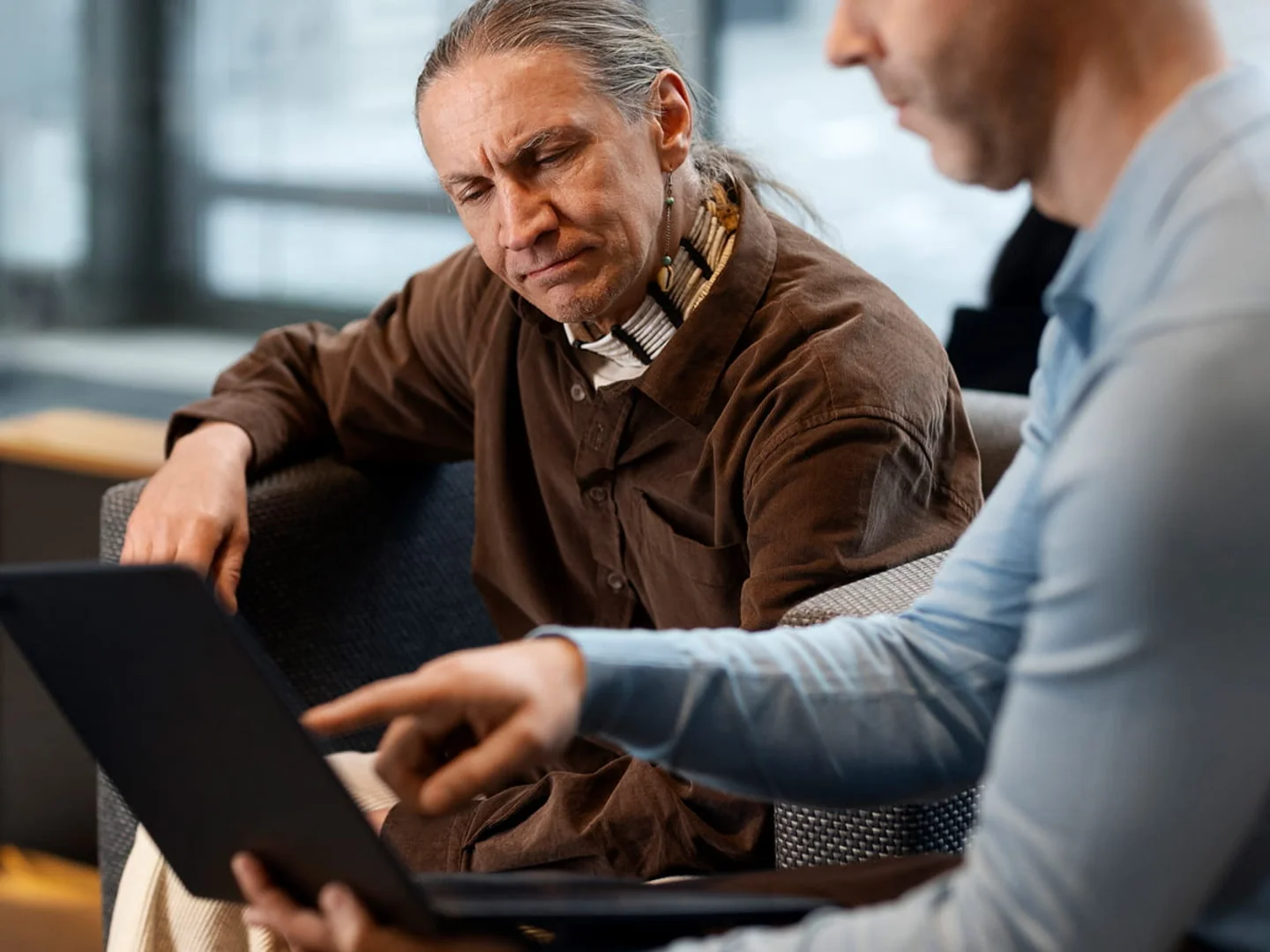 A person works at a laptop, reviewing data and case information